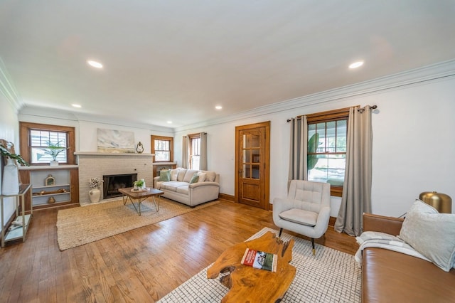 620 48th St, Des Moines, IA 50312 - living room with ornamental molding, plenty of natural light, a fireplace, wood finished floors, and recessed lighting