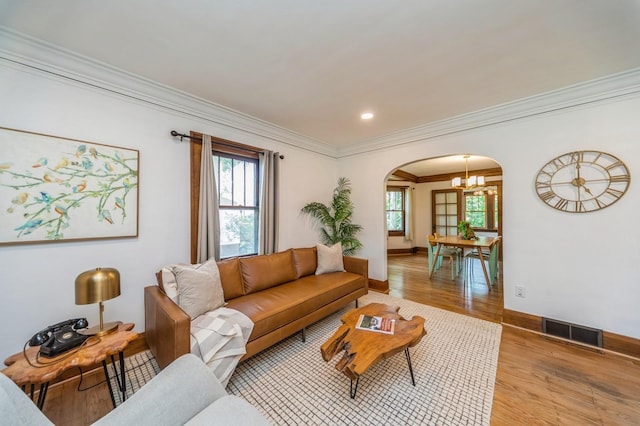 620 48th St, Des Moines, IA 50312 - living area featuring arched walkways, ornamental molding, plenty of natural light, wood finished floors, and recessed lighting