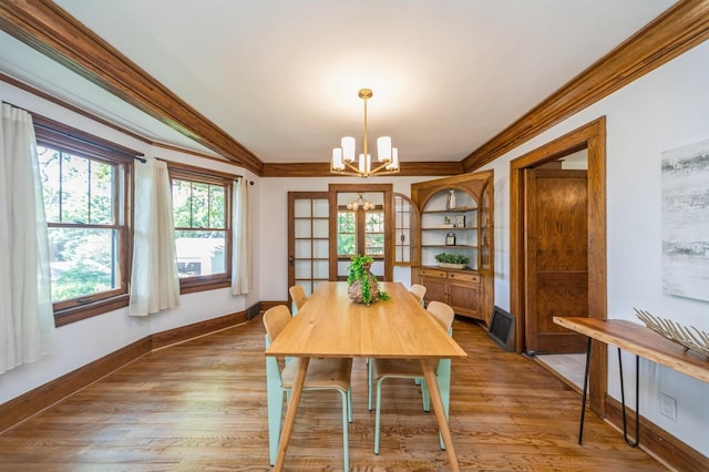 620 48th St, Des Moines, IA 50312 - dining space featuring a chandelier, crown molding, and wood finished floors