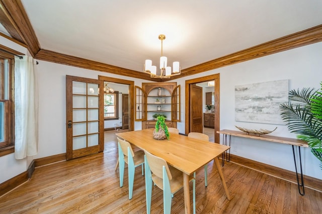 620 48th St, Des Moines, IA 50312 - dining room with crown molding, a chandelier, and light wood-style flooring