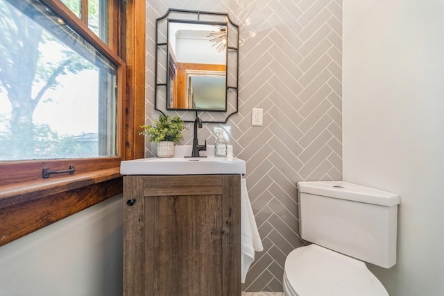 620 48th St, Des Moines, IA 50312 - bathroom featuring tile walls, vanity, and healthy amount of natural light