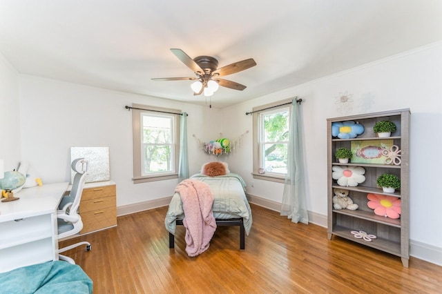 620 48th St, Des Moines, IA 50312 - bedroom with multiple windows, light wood-style flooring, ceiling fan, ornamental molding, and an office area