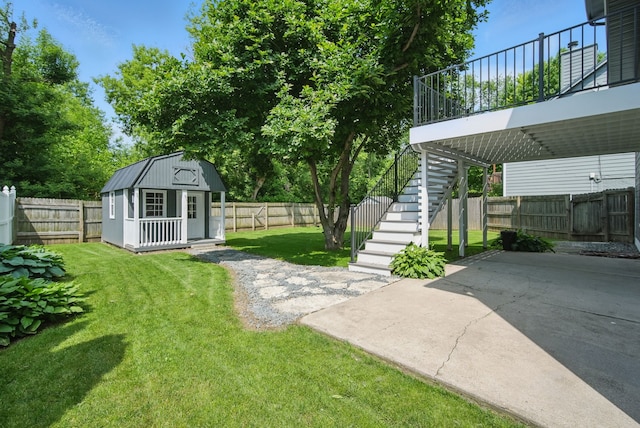 4510 89th St, Urbandale, IA 50322 - fenced backyard with stairs, an outbuilding, and a patio area