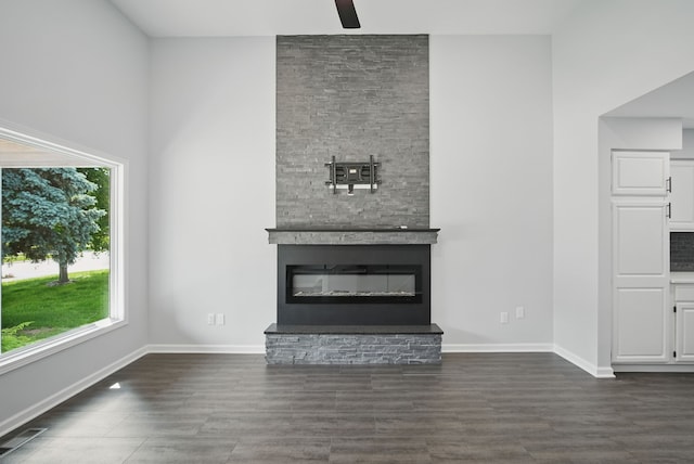4510 89th St, Urbandale, IA 50322 - unfurnished living room featuring a fireplace, a ceiling fan, dark wood-style floors, and a high ceiling