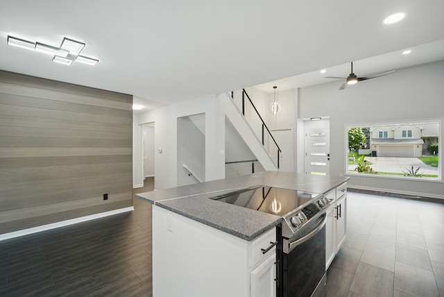 4510 89th St, Urbandale, IA 50322 - kitchen with electric range, recessed lighting, dark countertops, white cabinets, and open floor plan