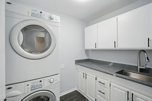 4510 89th St, Urbandale, IA 50322 - laundry area with stacked washer / dryer, cabinet space, and dark wood-style floors