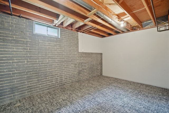 4510 89th St, Urbandale, IA 50322 - basement featuring carpet flooring and brick wall