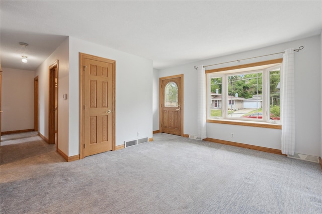 2441 Hull Ave, Des Moines, IA 50317 - entryway with light colored carpet and baseboards