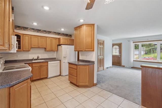 2441 Hull Ave, Des Moines, IA 50317 - kitchen with white appliances, light carpet, dark countertops, recessed lighting, and glass insert cabinets