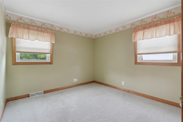2441 Hull Ave, Des Moines, IA 50317 - spare room with plenty of natural light and carpet floors