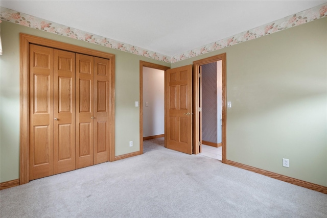 2441 Hull Ave, Des Moines, IA 50317 - unfurnished bedroom with a closet and light carpet