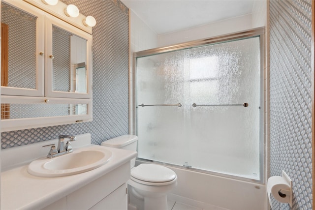2441 Hull Ave, Des Moines, IA 50317 - full bathroom with enclosed tub / shower combo, vanity, and wallpapered walls