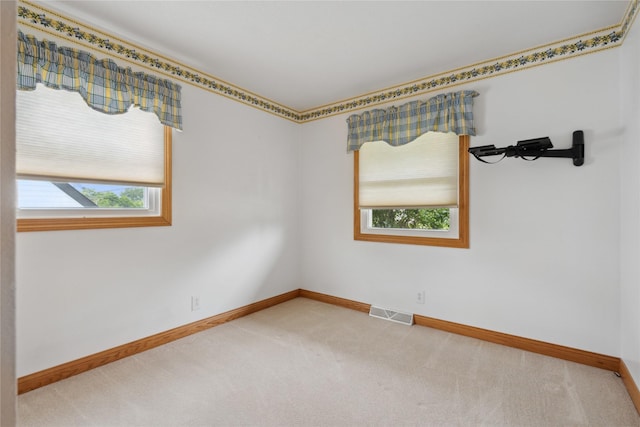 2441 Hull Ave, Des Moines, IA 50317 - empty room featuring carpet flooring and healthy amount of natural light