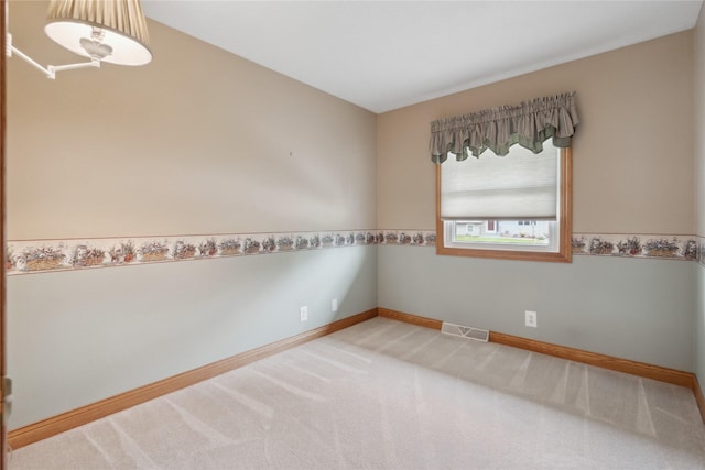 2441 Hull Ave, Des Moines, IA 50317 - carpeted spare room featuring baseboards