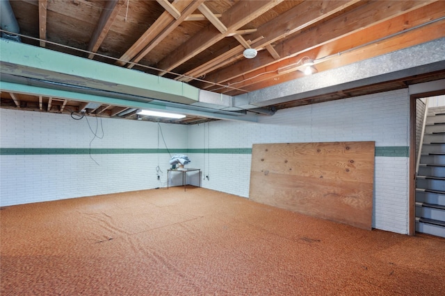 2441 Hull Ave, Des Moines, IA 50317 - unfinished below grade area with carpet flooring and brick wall