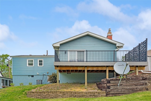2441 Hull Ave, Des Moines, IA 50317 - back of house with a deck, a chimney, and a lawn