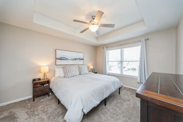 150 SE Hazelwood Dr, Waukee, IA 50263 - bedroom with a raised ceiling, light colored carpet, and ceiling fan