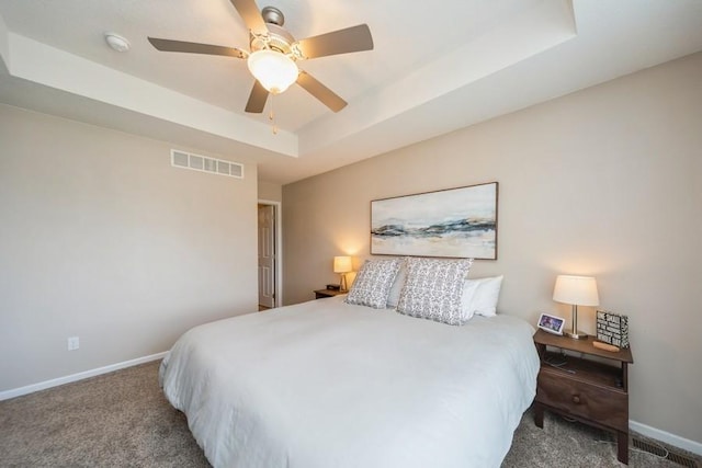 150 SE Hazelwood Dr, Waukee, IA 50263 - bedroom with a tray ceiling, carpet floors, and ceiling fan