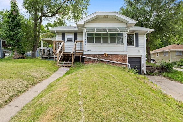 2355 Saylor Rd, Des Moines, IA 50313 - manufactured / mobile home featuring an attached garage, asphalt driveway, a front lawn, and a wooden deck
