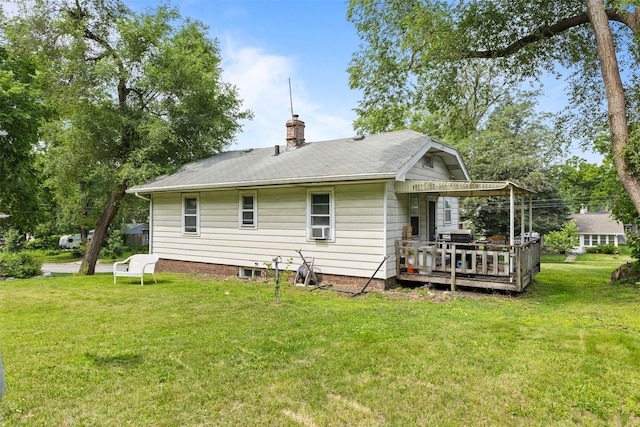2355 Saylor Rd, Des Moines, IA 50313 - rear view of house featuring a chimney, a wooden deck, and a lawn