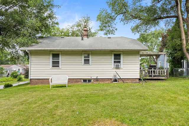 2355 Saylor Rd, Des Moines, IA 50313 - rear view of property featuring a yard, cooling unit, a chimney, and a deck