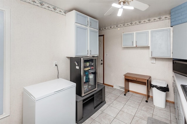 4080 SE 15th Ct, Des Moines, IA 50320 - laundry room with a ceiling fan and light tile patterned flooring