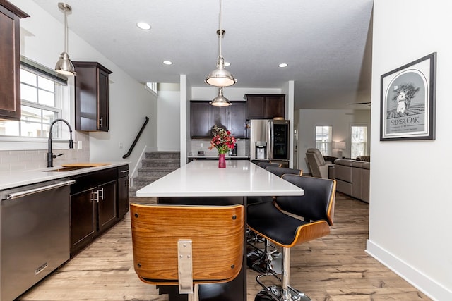 5477 S Prairie View Dr, West Des Moines, IA 50266 - kitchen featuring stainless steel appliances, backsplash, healthy amount of natural light, light countertops, and recessed lighting