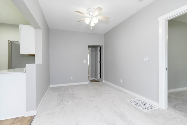 2537 Maple St, Des Moines, IA 50317 - spare room with a ceiling fan and light colored carpet