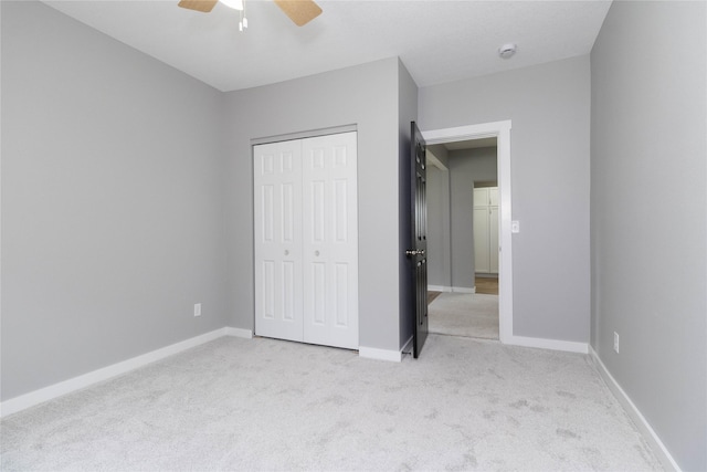 2537 Maple St, Des Moines, IA 50317 - unfurnished bedroom featuring light carpet, a closet, and ceiling fan
