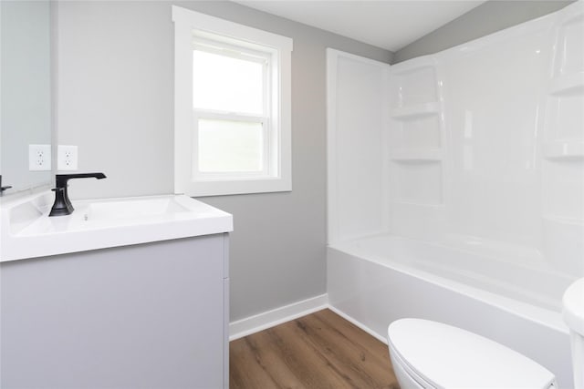 2537 Maple St, Des Moines, IA 50317 - bathroom with vanity, wood finished floors, and tub / shower combination