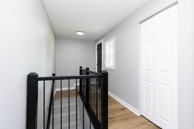 2537 Maple St, Des Moines, IA 50317 - corridor with an upstairs landing and light wood-style flooring