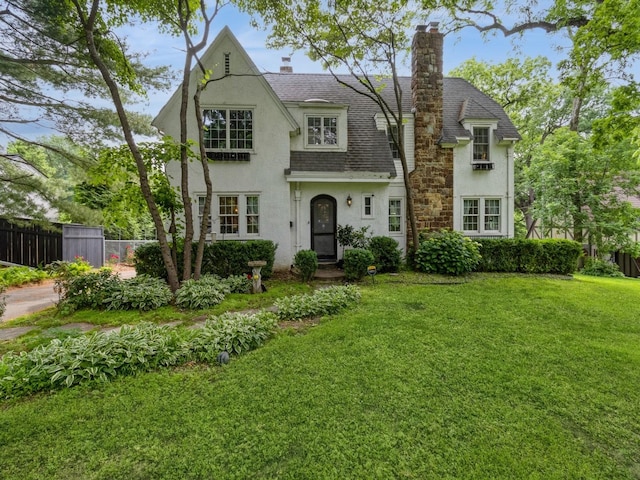 215 Foster Dr, Des Moines, IA 50312 - english style home with stucco siding, a shingled roof, and a chimney