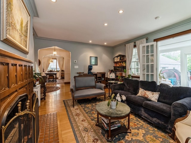 215 Foster Dr, Des Moines, IA 50312 - living area with arched walkways, ornamental molding, light wood finished floors, and recessed lighting
