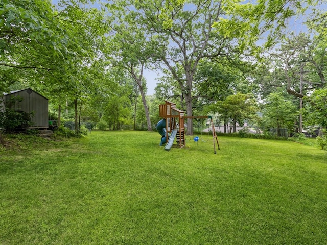215 Foster Dr, Des Moines, IA 50312 - view of green lawn with a playground and a storage unit