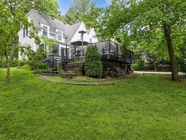 215 Foster Dr, Des Moines, IA 50312 - back of house featuring a deck, a yard, and a chimney