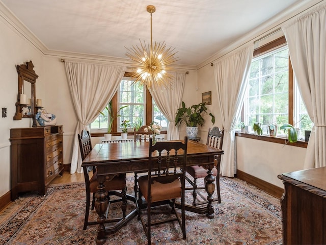 215 Foster Dr, Des Moines, IA 50312 - dining room featuring a chandelier, wood finished floors, plenty of natural light, and crown molding