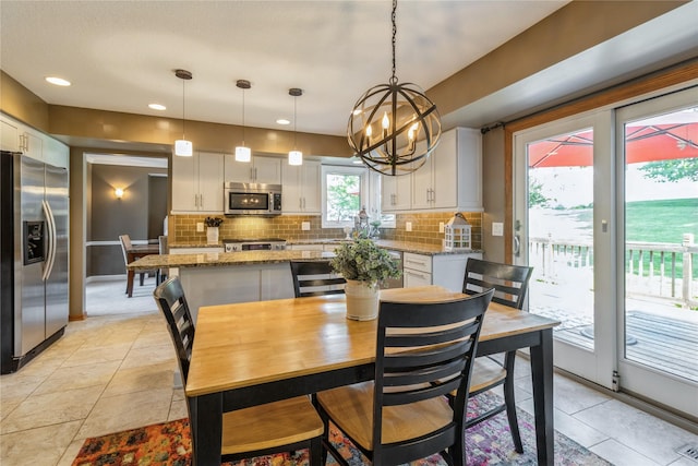 281 58th Ct, West Des Moines, IA 50266 - dining room with a chandelier, light tile patterned floors, and recessed lighting