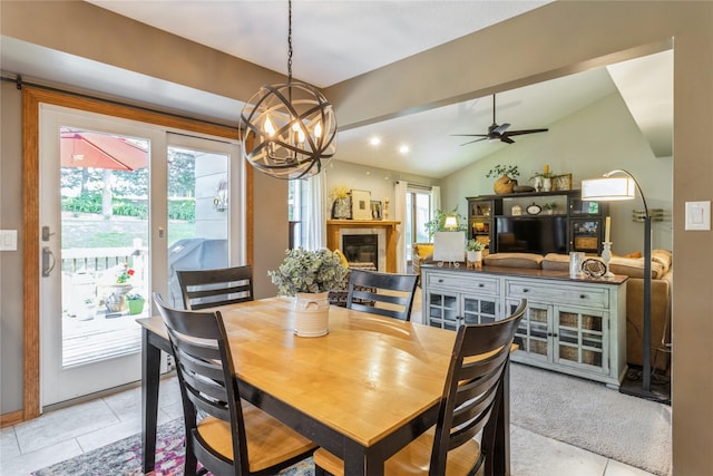 281 58th Ct, West Des Moines, IA 50266 - dining area featuring a chandelier, vaulted ceiling, a fireplace, light tile patterned floors, and a ceiling fan