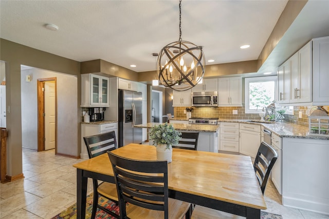 281 58th Ct, West Des Moines, IA 50266 - dining area with a chandelier and recessed lighting