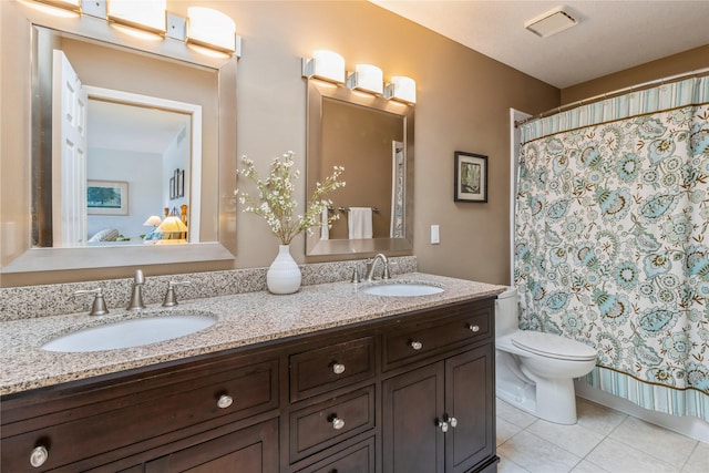 281 58th Ct, West Des Moines, IA 50266 - ensuite bathroom featuring double vanity, tile patterned floors, and a shower with curtain