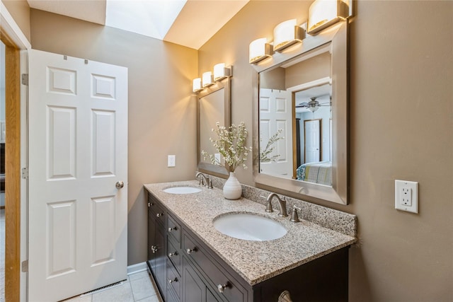 281 58th Ct, West Des Moines, IA 50266 - ensuite bathroom with double vanity, tile patterned floors, and ceiling fan
