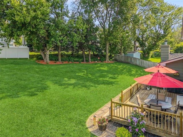 281 58th Ct, West Des Moines, IA 50266 - view of yard with a wooden deck and outdoor dining area