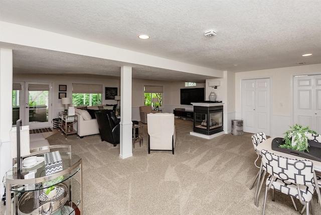 5395 NW 72nd Pl, Johnston, IA 50131 - carpeted living room with a textured ceiling, a fireplace, and recessed lighting