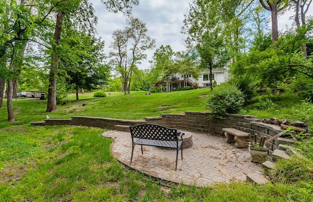 5395 NW 72nd Pl, Johnston, IA 50131 - view of grassy yard featuring a patio and a fire pit