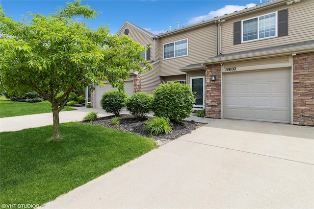 8610 Ep True Pkwy Unit 14002, West Des Moines, IA 50266 - multi unit property featuring stone siding, concrete driveway, and a front lawn
