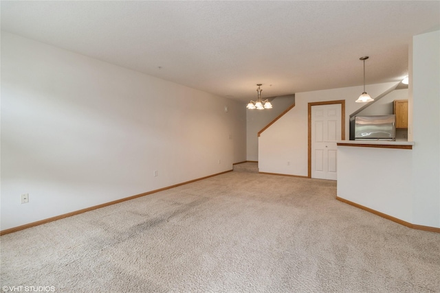 8610 Ep True Pkwy Unit 14002, West Des Moines, IA 50266 - unfurnished living room featuring light colored carpet and a chandelier