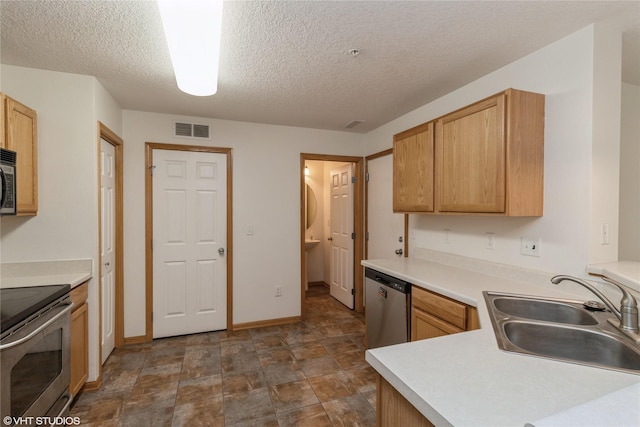 8610 Ep True Pkwy Unit 14002, West Des Moines, IA 50266 - kitchen with appliances with stainless steel finishes, a textured ceiling, stone finish floors, and light countertops