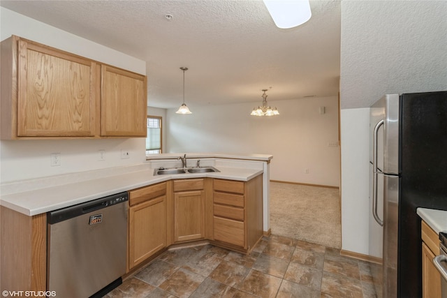 8610 Ep True Pkwy Unit 14002, West Des Moines, IA 50266 - kitchen with stainless steel appliances, a peninsula, decorative light fixtures, a chandelier, and light countertops