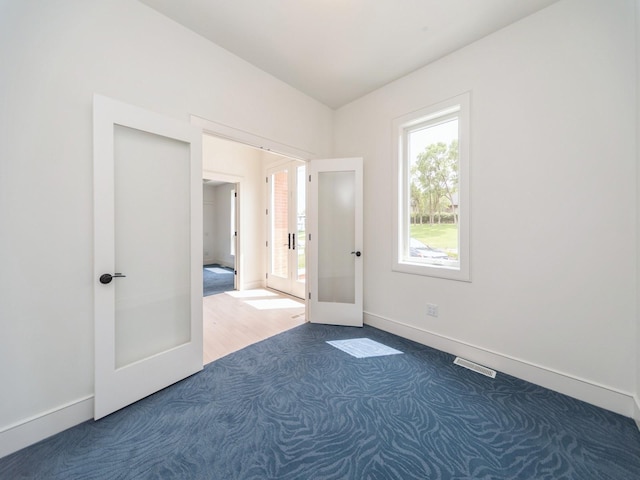 1863 Glen Oaks Dr, West Des Moines, IA 50266 - carpeted empty room featuring french doors and baseboards