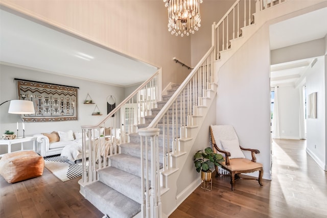 1720 Cedarwood Cir, Clive, IA 50325 - stairway with hardwood / wood-style floors, ornamental molding, a high ceiling, and a chandelier